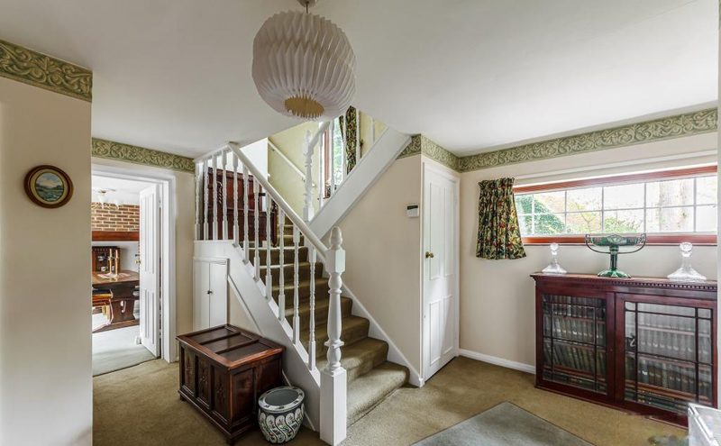 A landing with a balustraded staircase, window and doors to the bedrooms.